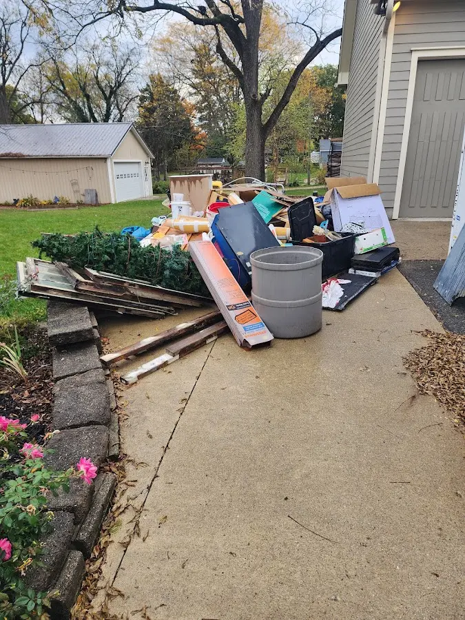 Dumpster being loaded with debris for 30 Yard Dumpster Rental in Kentwood